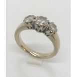 A diamond three stone ring set in unmarked 18ct white gold, the centre stone being approx 0.75ct