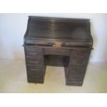An vintage Angus (London) oak roll top desk