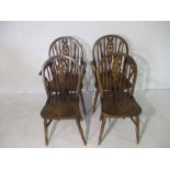 Four Windsor style wheelback chairs, including two carvers