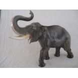 A ceramic elephant. Height 41cm. Has had a repair to one tusk. AF