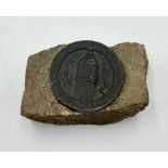 A WW2 paperweight bearing a cast lead plaque and made from stone recovered from the Houses of