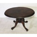 A Victorian walnut veneered tip up table