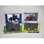 A collection of four boxed die-cast tractors (1:32 scale), including a Britains John Deere 9530