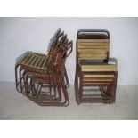 A set of twelve tubular and slatted stacking chairs - few slats missing