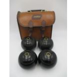 A set of four Thomas Taylor (size 4) lawn bowls in leather Mitre carry case