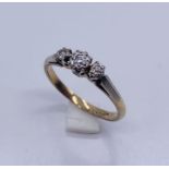A diamond three stone ring set in 9ct gold and platinum
