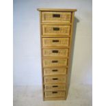 A modern narrow chest of nine wicker drawers - A/F