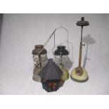 A collection of three tilly lamps including one table model, along with a hanging lantern