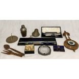 A collection of assorted items including a bell, cocktail shaker, barometer, Stanley compass and