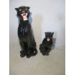 Two ceramic fireside black Panthers. Left fang on large panther is chipped. Heights are 84cm and