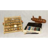 A small collection of toys including a Chinese abacus, Pixiephone glockenspiel, handmade submarine