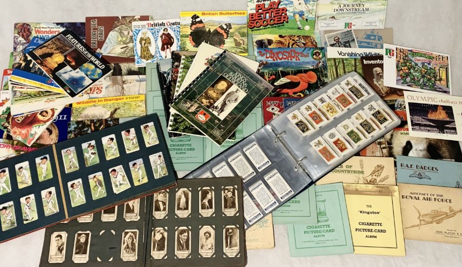 A large collection of cigarette cards, tea cards and trade cards including Wills, Players,