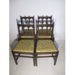 A set of four Ercol dining chairs with carved detailing