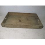 A large wooden bakers tray.