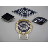 Four vintage Riley enamelled car badges including a Golden Jubilee badge and three others