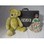 A vintage BEA carry bag along with a vintage plush teddy bear and a doll