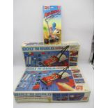 Two boxed Action GT Bolt N Build remote control action sets, along with Tomy AFX Rip Riders