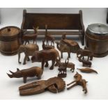 A collection of various items including biscuit barrels, small wooden bookshelf, wooden animals (