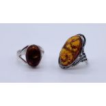Two 925 silver rings set with amber