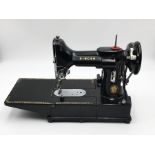 A cased Singer Electric Sewing Machine, Model 222K. To include instruction Manuel, replacement
