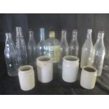 A collection of vintage glass bottles including Essolube, Corona, H & A Gilbley Ltd, Dawe Paignton