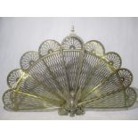 A brass fan shaped fire screen.