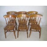 A set of six slat back dining chairs.