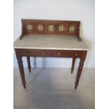 An Edwardian tile backed marble topped washstand with two drawers under.