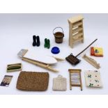 A collection of miniature dolls house kitchen items including ironing board, step ladder, carpet