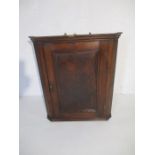 A Georgian oak corner cupboard - height 85cm