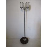 An Art Deco floor lamp with frosted light shades