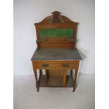 An Edwardian satinwood washstand with grey marble top, green tiled backed and single drawer,