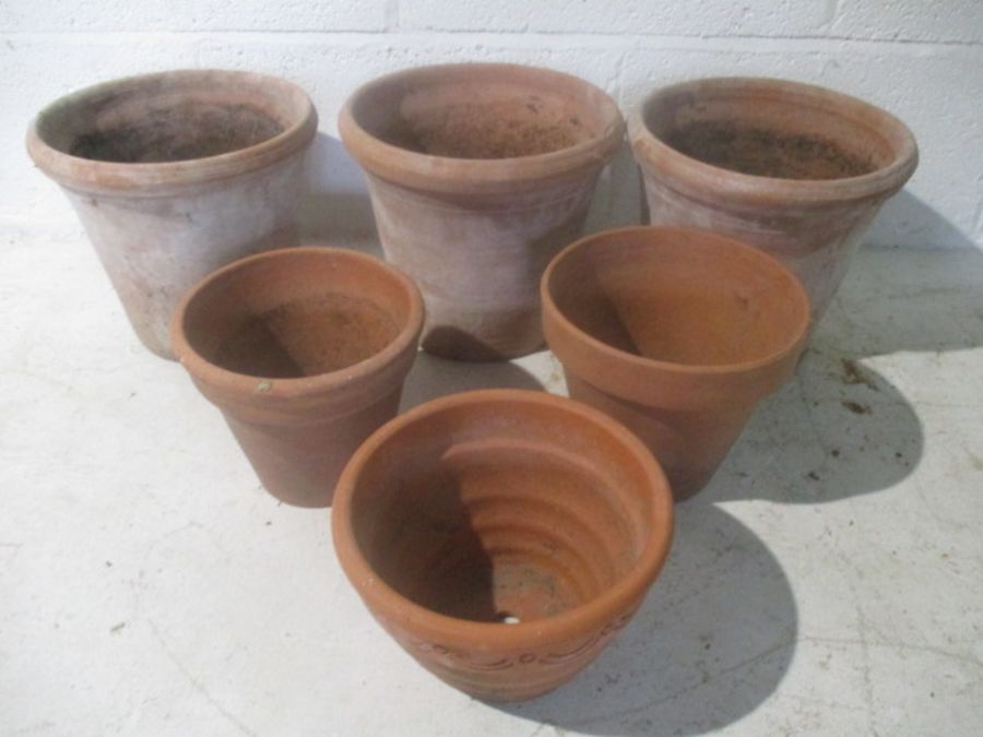 A small collection of terracotta flowerpots