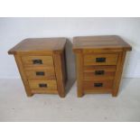 A pair of oak bedside cabinets