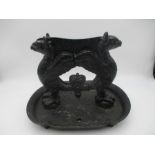 A Victorian cast iron boot scrapper decorated with twin griffins