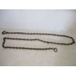 A vintage cast iron link chain with hook to one end