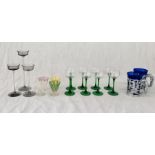 A collection of glassware including long stem glasses, vintage ice cream glasses, Wedgwood candle