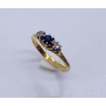 An 18ct gold diamond and sapphire three stone ring