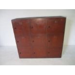 A vintage wooden painted school locker unit with nine cupboards