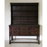 A vintage oak dresser on twisted legs with two drawers and cupboards under