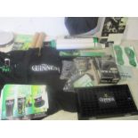 An assortment of Guinness promotional items, including beer mats, flags, key rings, poster, drip