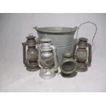 Three vintage lamps along with a galvanised bucket and Powell & Hanmer "New Sultan" carbide cycle