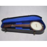 A vintage four string Banjolele in carry case