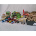 A collection of Brio style train items including trains, bridges, track etc.
