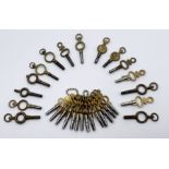 A collection of watch keys including a graduated set of fourteen pocket watch keys