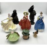 A collection of various ornaments including three Royal Doulton ladies, a Beswick duck, two