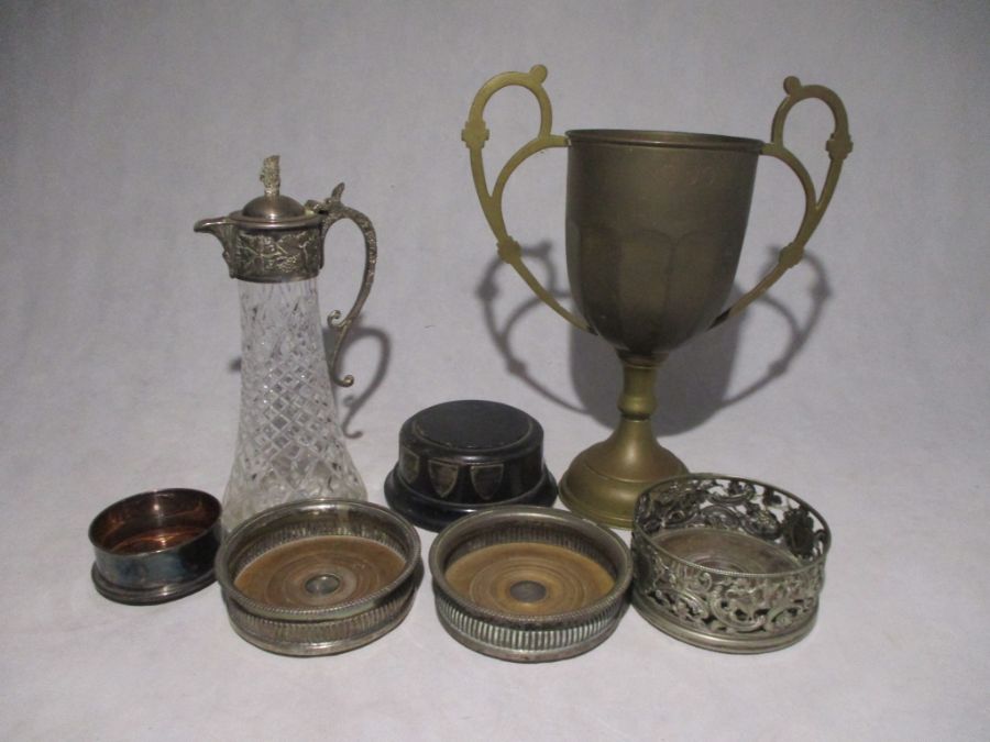 An antique brass trophy engraved with Maldive Ashes, along with a small collection of silver