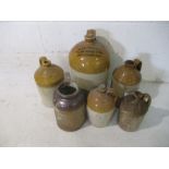 A collection of five stoneware cider flagons, one marked with William Hancock & Sons (