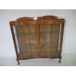 An Art Deco freestanding serpentine fronted display cabinet - Overall height 125cm, width 120cm,