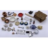 A collection of miniature dolls house items mainly kitchen related - tea sets, basket, cutlery etc